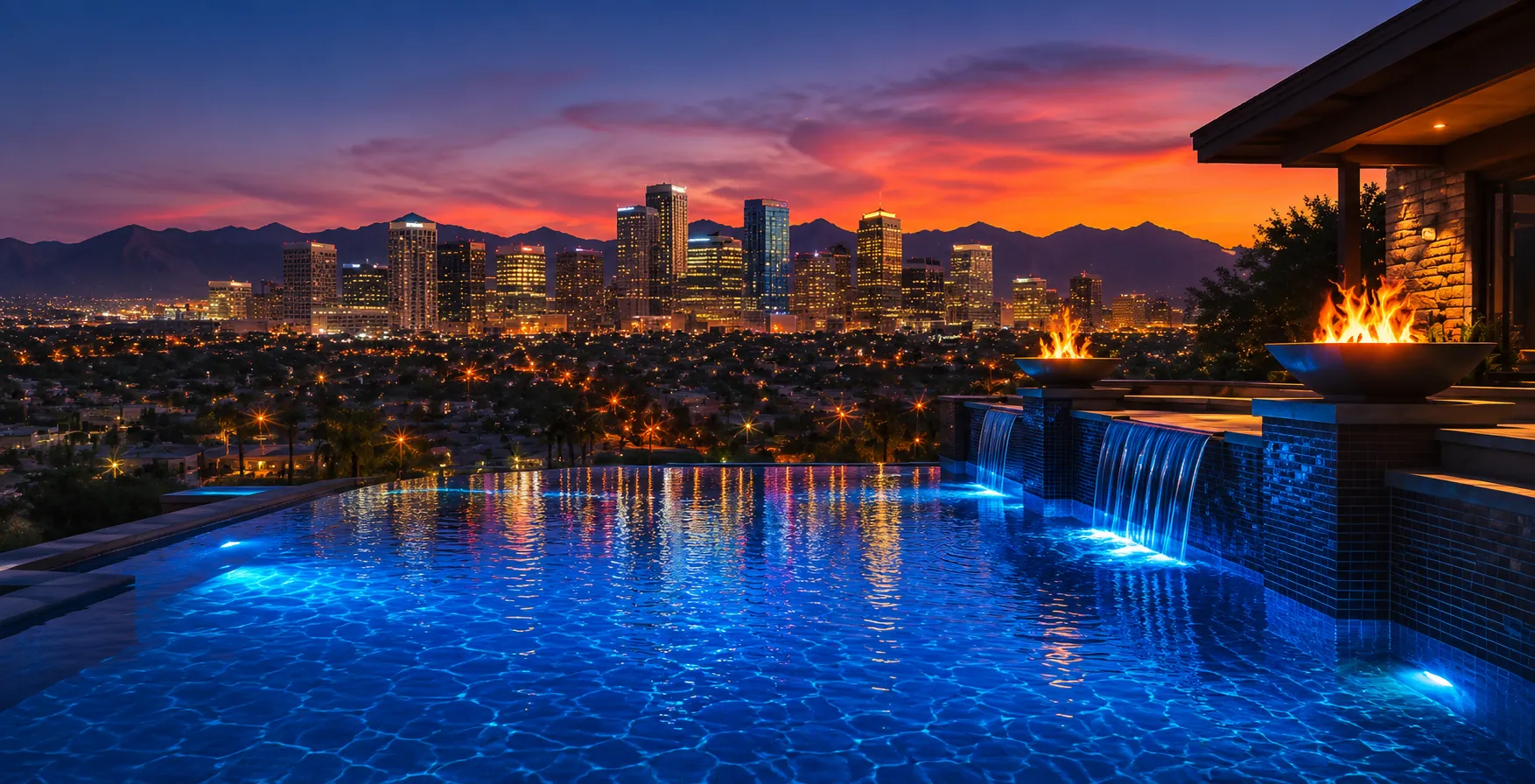 Custom inground infinity pool with fire bowls overlooking the Phoenix, Arizona skyline at sunset β Arizona pool builder marketing